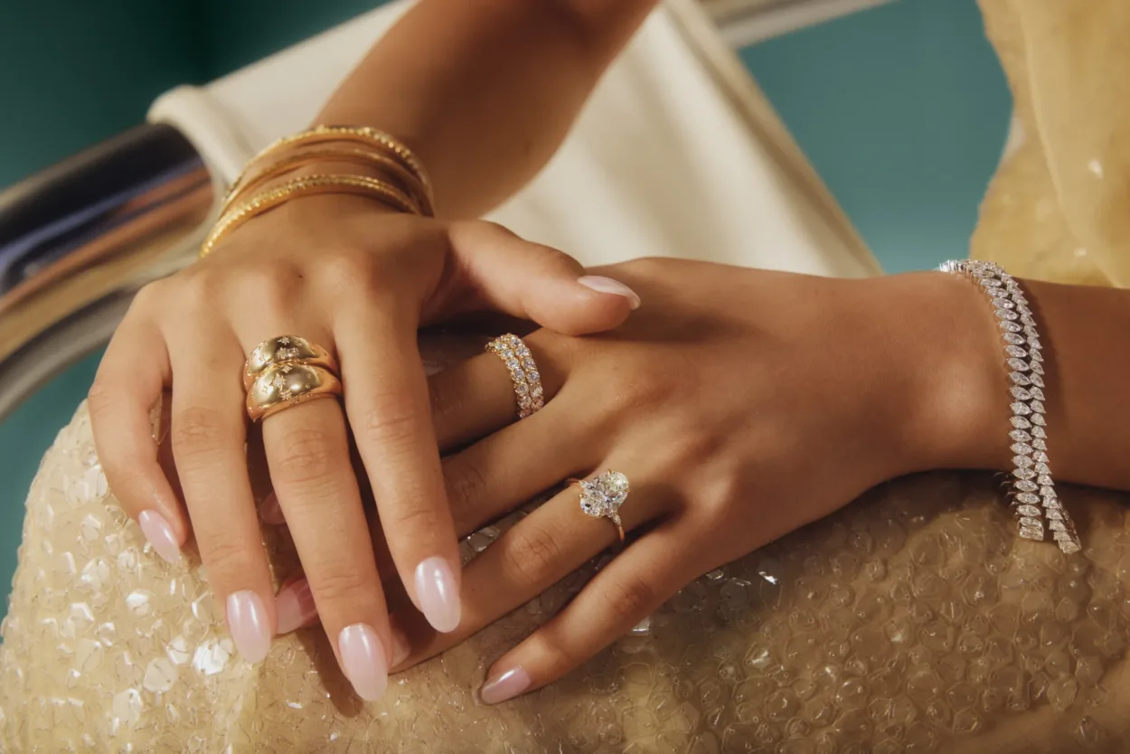 close up of hands adorned with sparkly jewelry