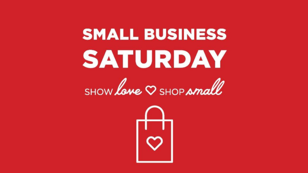 white text saying small business saturday show love shop small graphic with a shopping bag with a heart on it with a red background