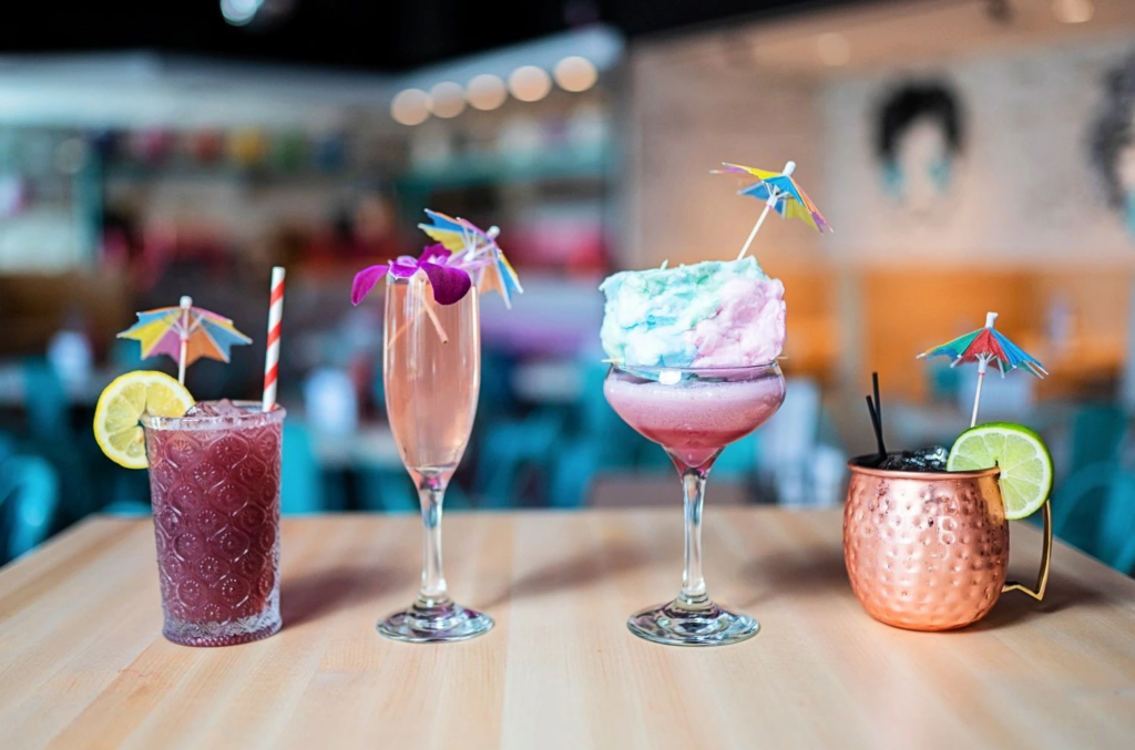 a row of colorful cocktails on a table