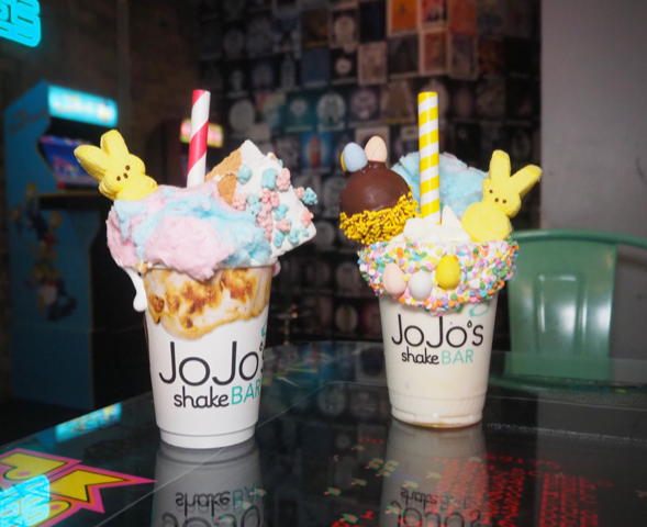 Two colorful, Easter-themed milk shakes on a table.