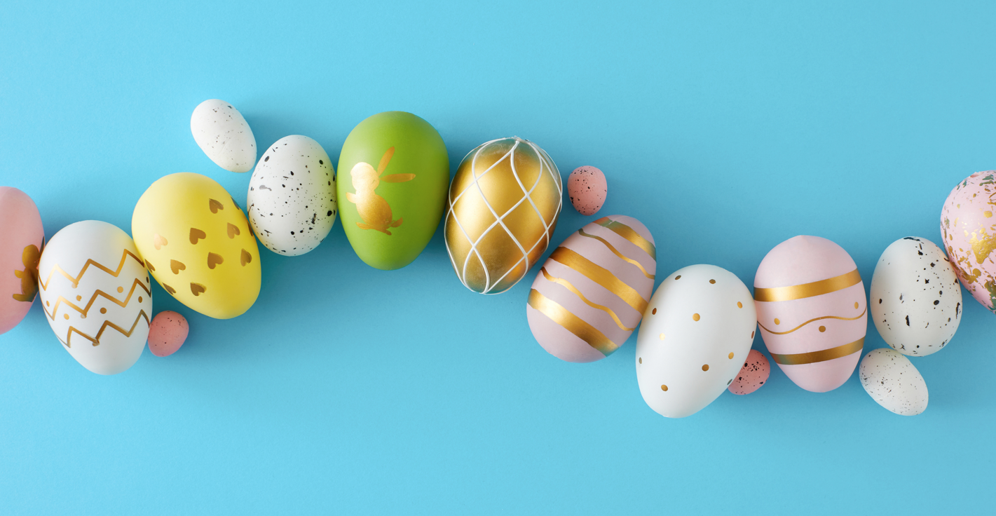 Colorful Easter eggs lined up on a blue background