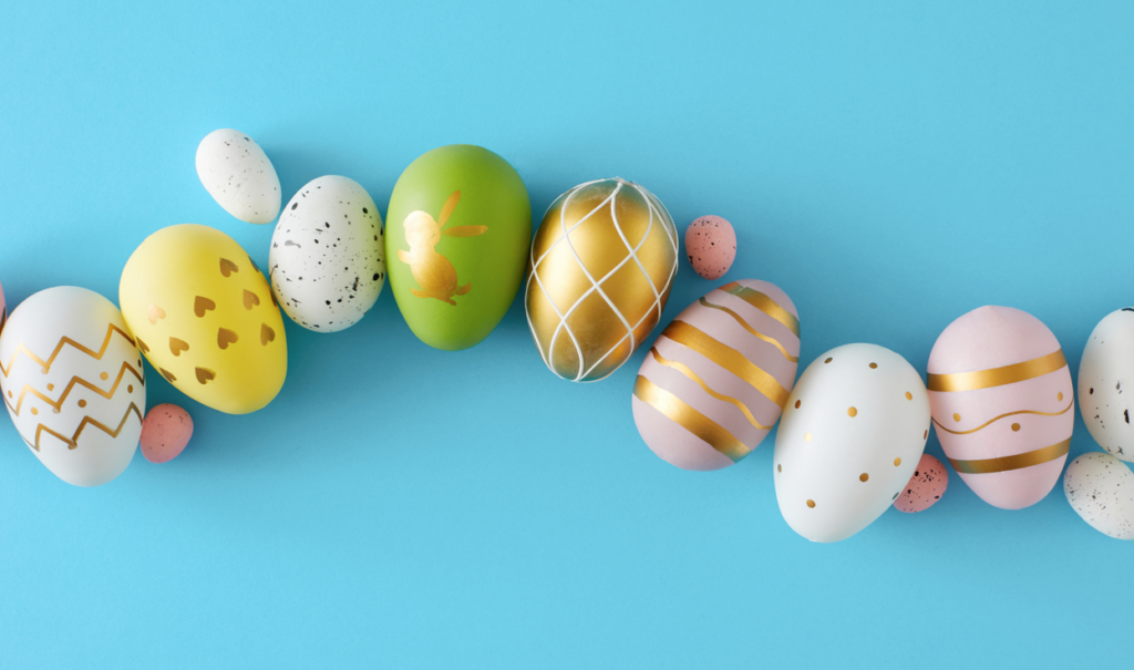 Colorful Easter eggs lined up on a blue background