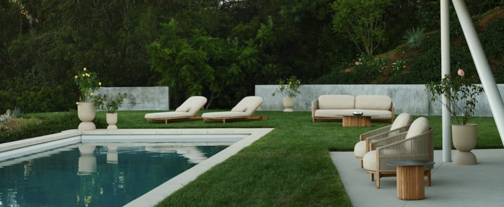 Outdoor furniture set next to a pool