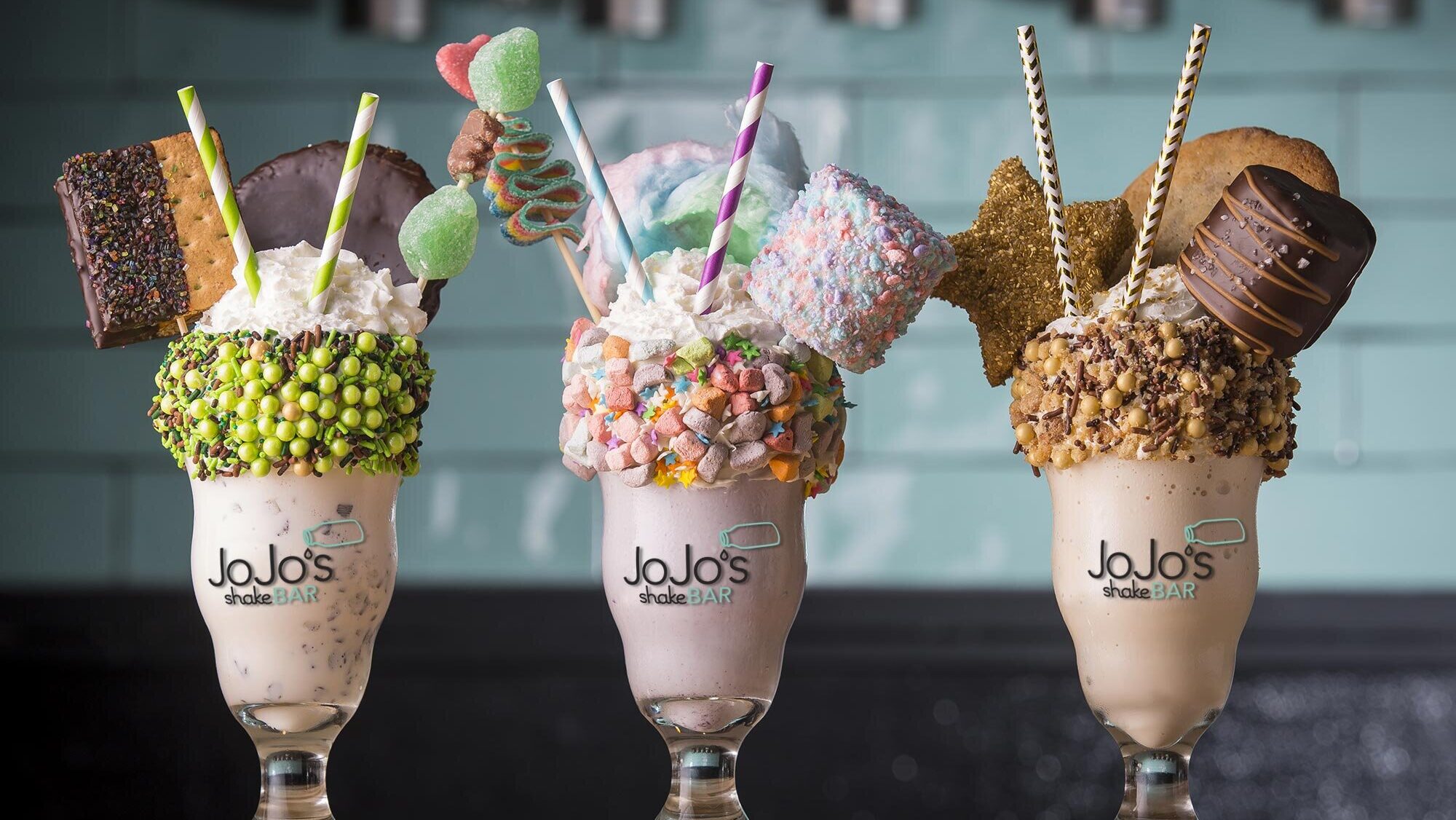 Three over-the-top milkshakes with lots of toppings