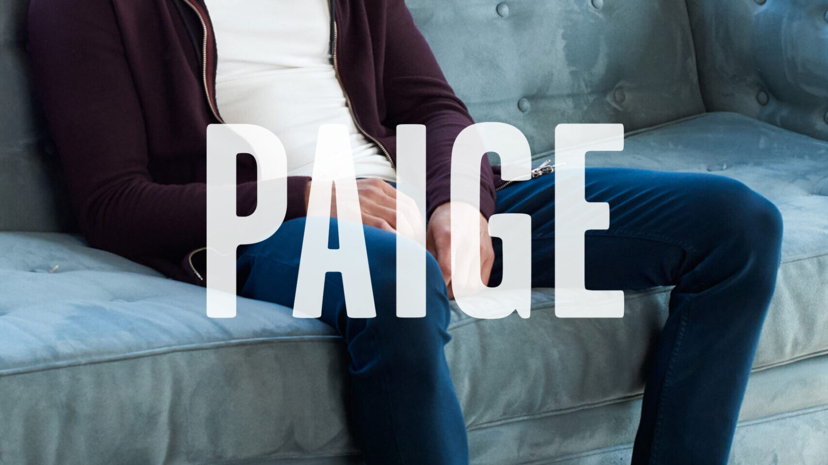 PAIGE logo overlay on an image of a person wearing jeans, sitting on a couch