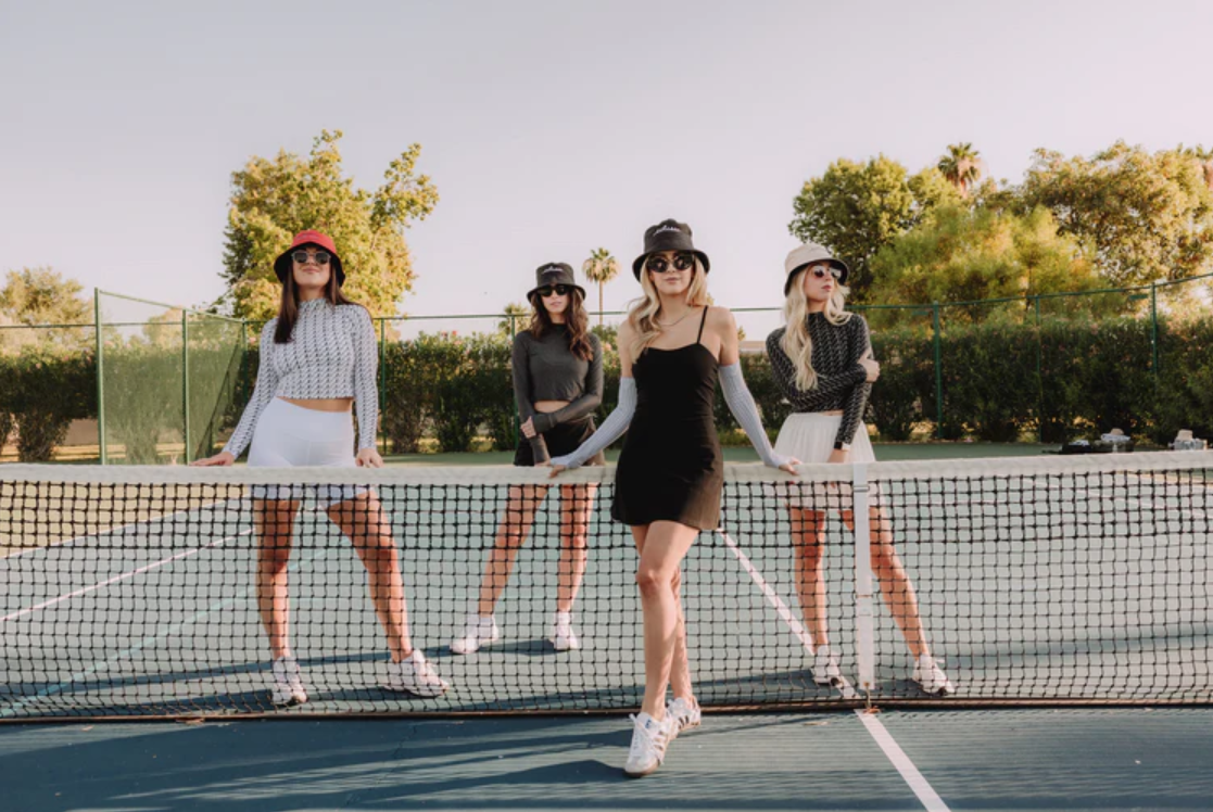 A group of ladies on a tennis court