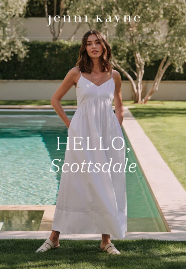 A woman in a white dress, standing next to a pool