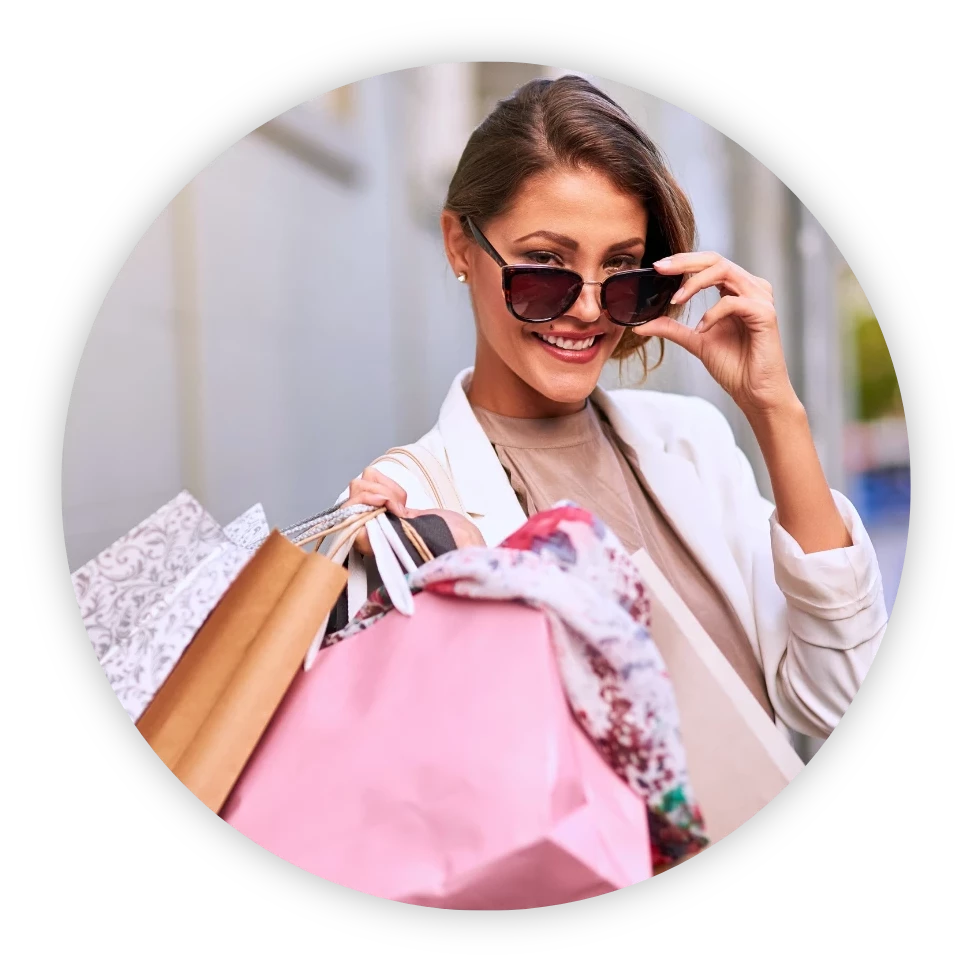 A woman with shopping bags wearing sunglasses