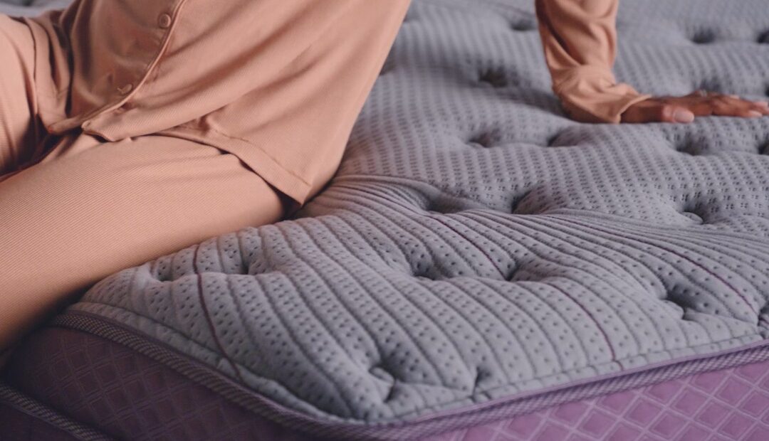 A person sitting on a Purple mattress