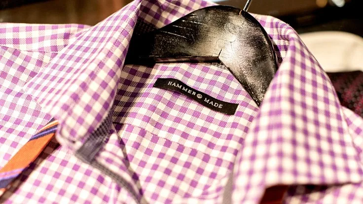 A close up photo of a dress shirt with a hammer made tag