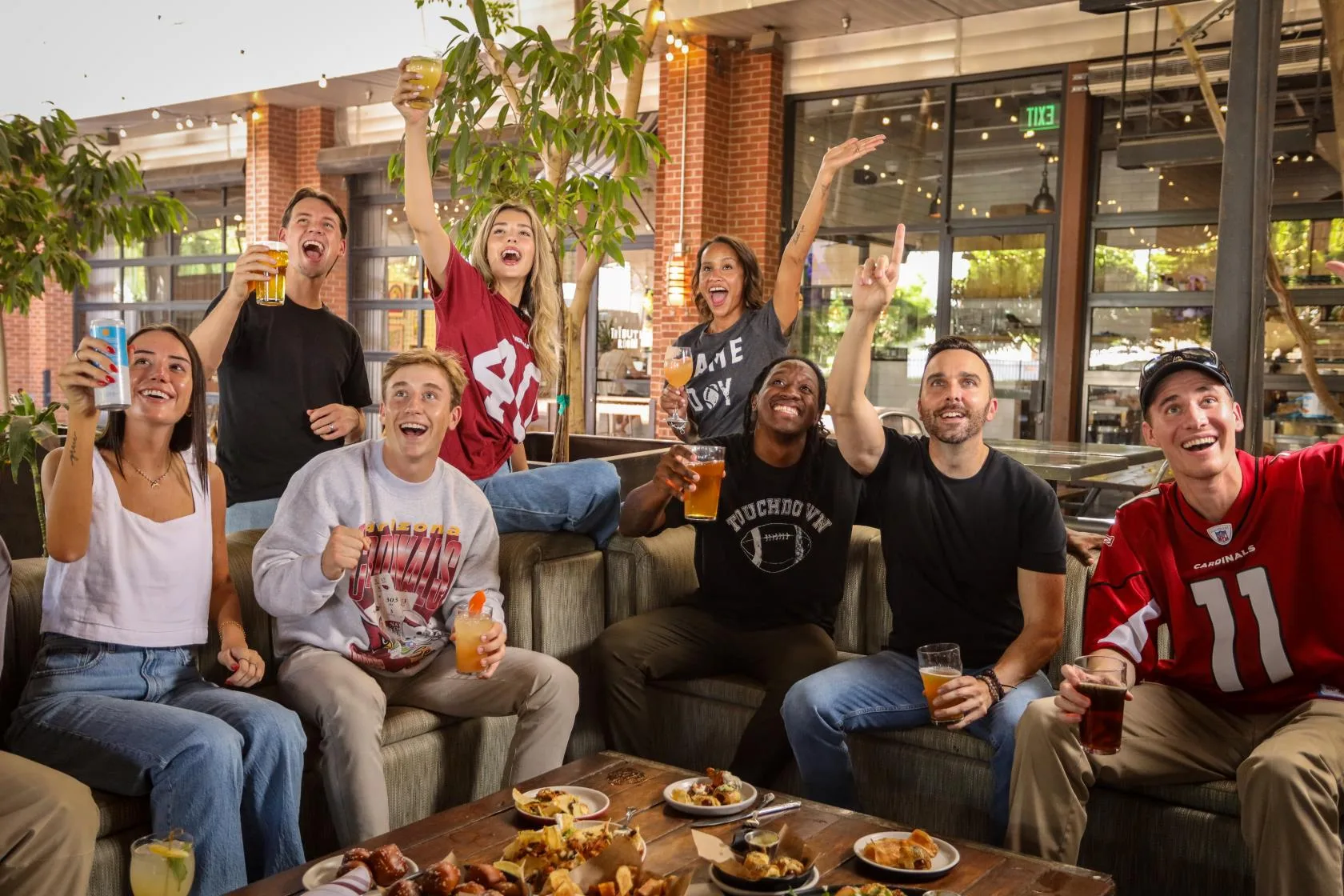 Football fans gathered around a table at a restaurant