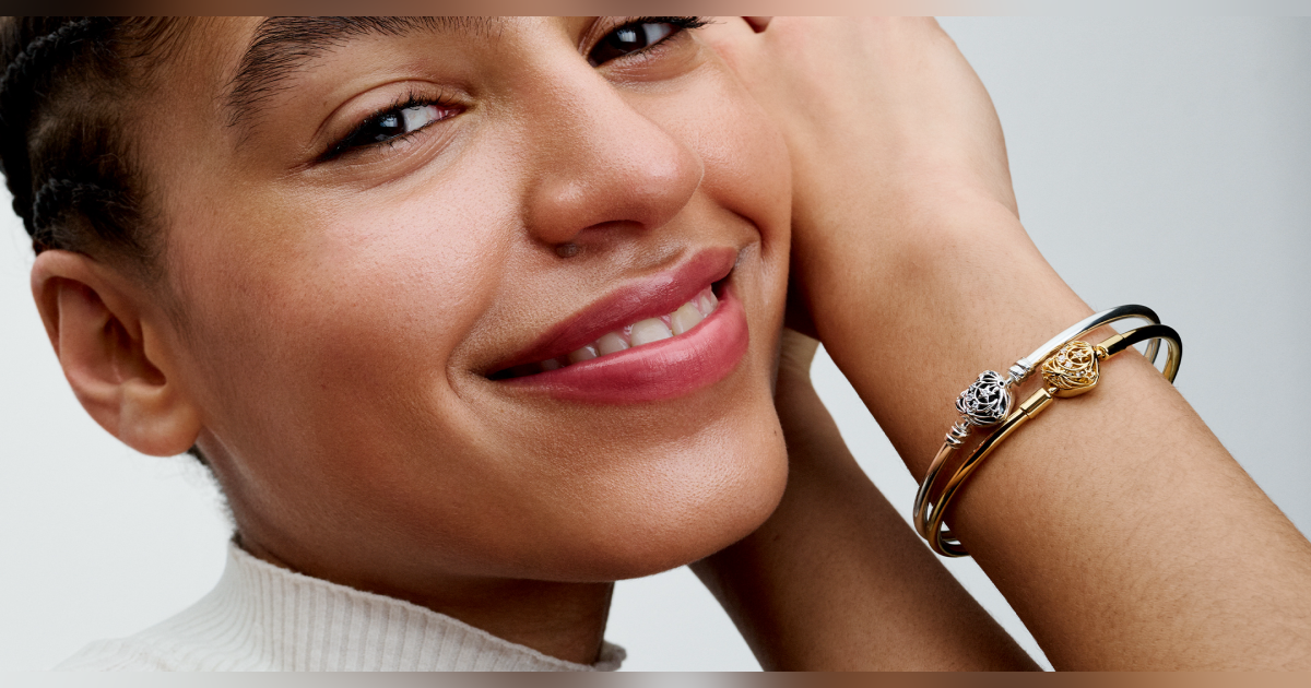 A woman wearing gold and silver bangles