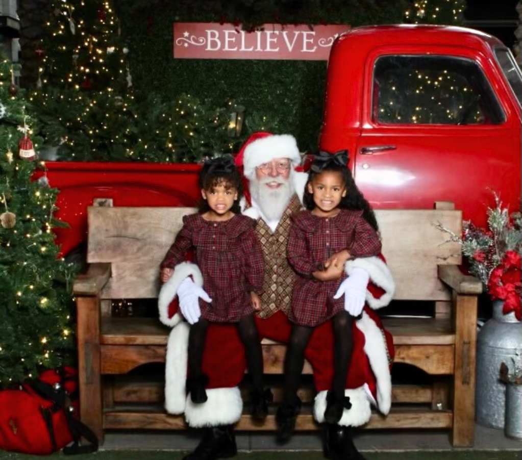 Children sitting on Santa's lap, in front of a truck at Scottsdale Quarter.