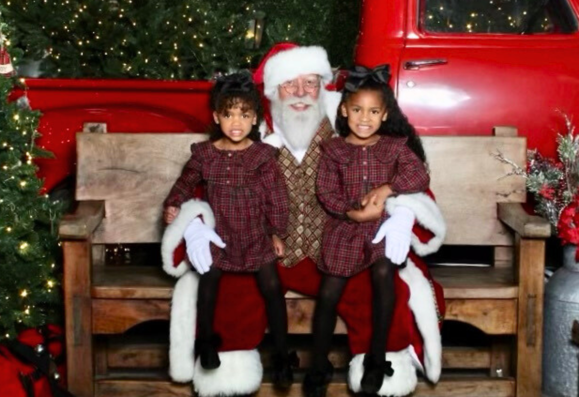 Children sitting on Santa's lap, in front of a truck at Scottsdale Quarter.