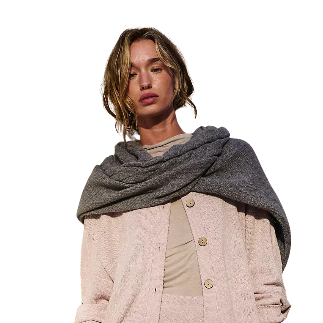 a woman in a grey scarf and a white sweater