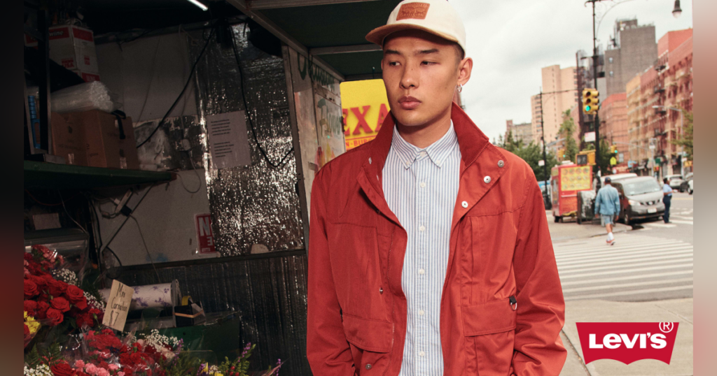 a man walking down the street wearing casual clothing