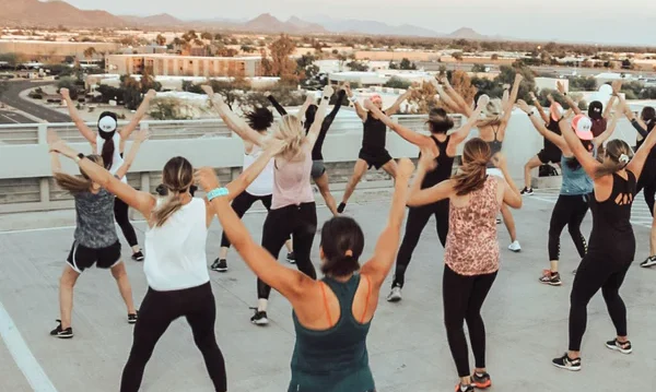 A group of people exercising on a roof