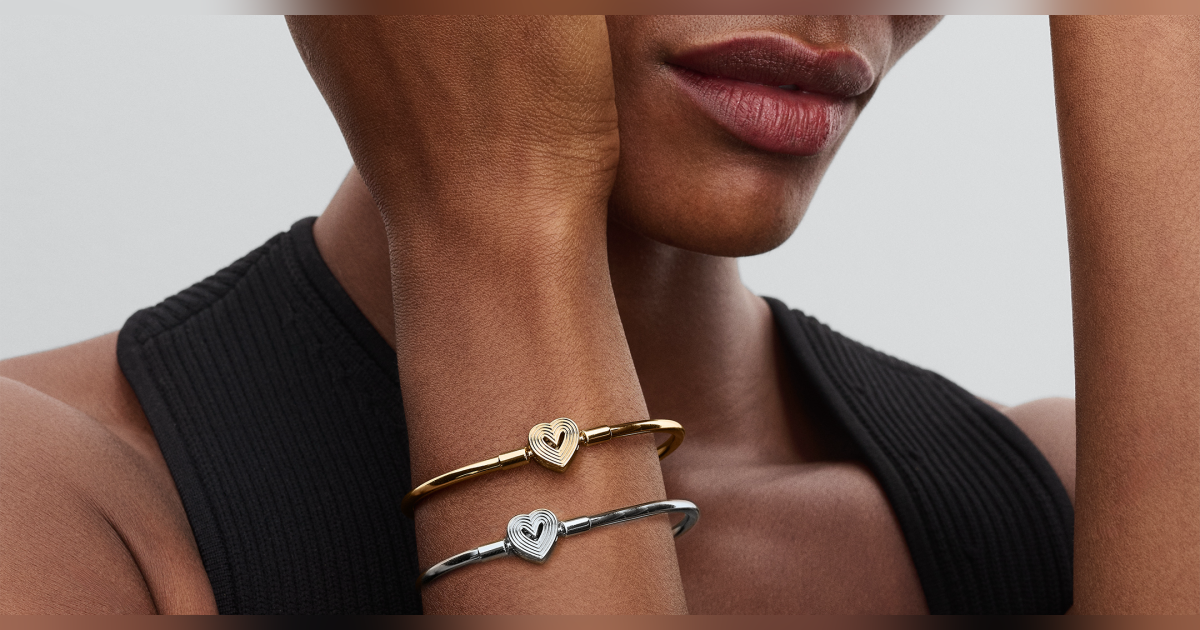 a woman wearing silver and gold bracelets