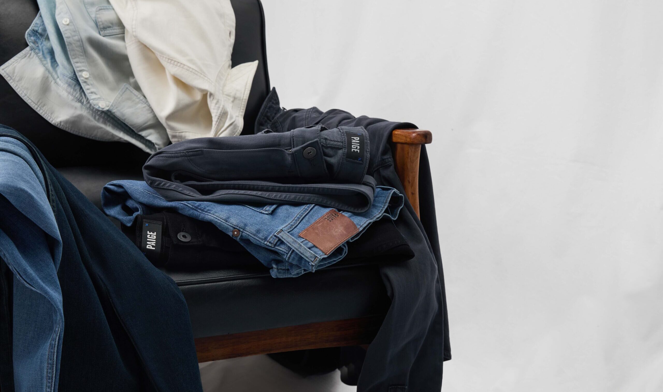 A pile of clothing draped on a chair