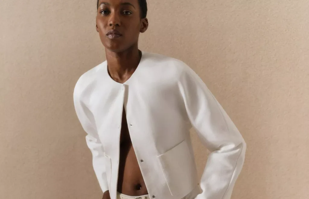 a woman in a white skirt and jacket