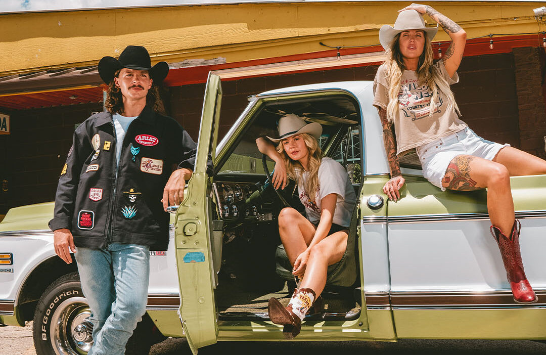 People in western apparel sitting in a truck