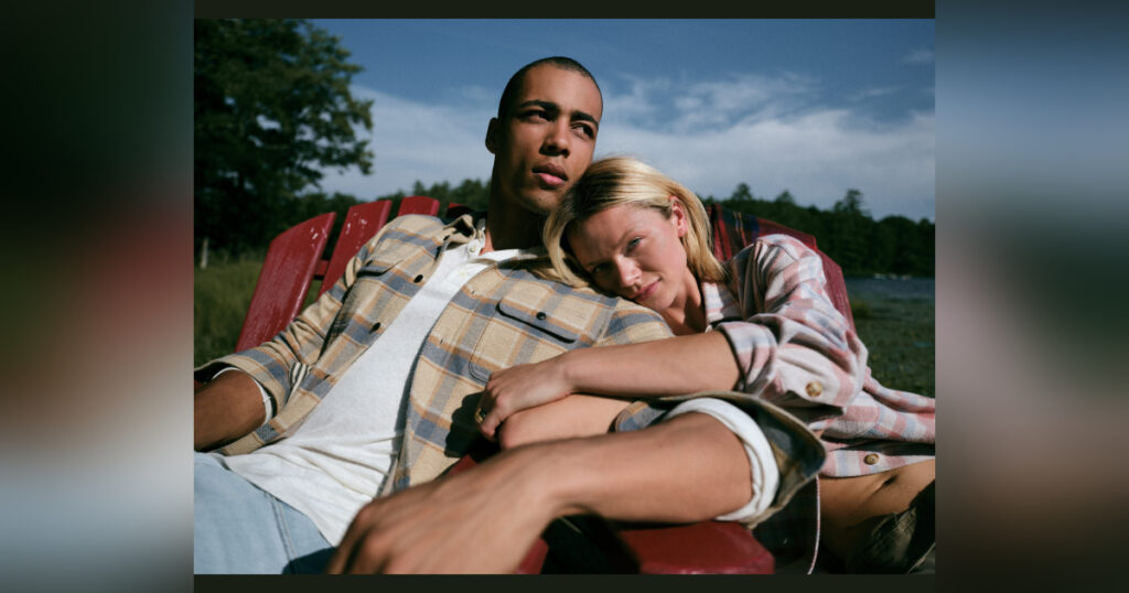 A couple lounging in fall clothes