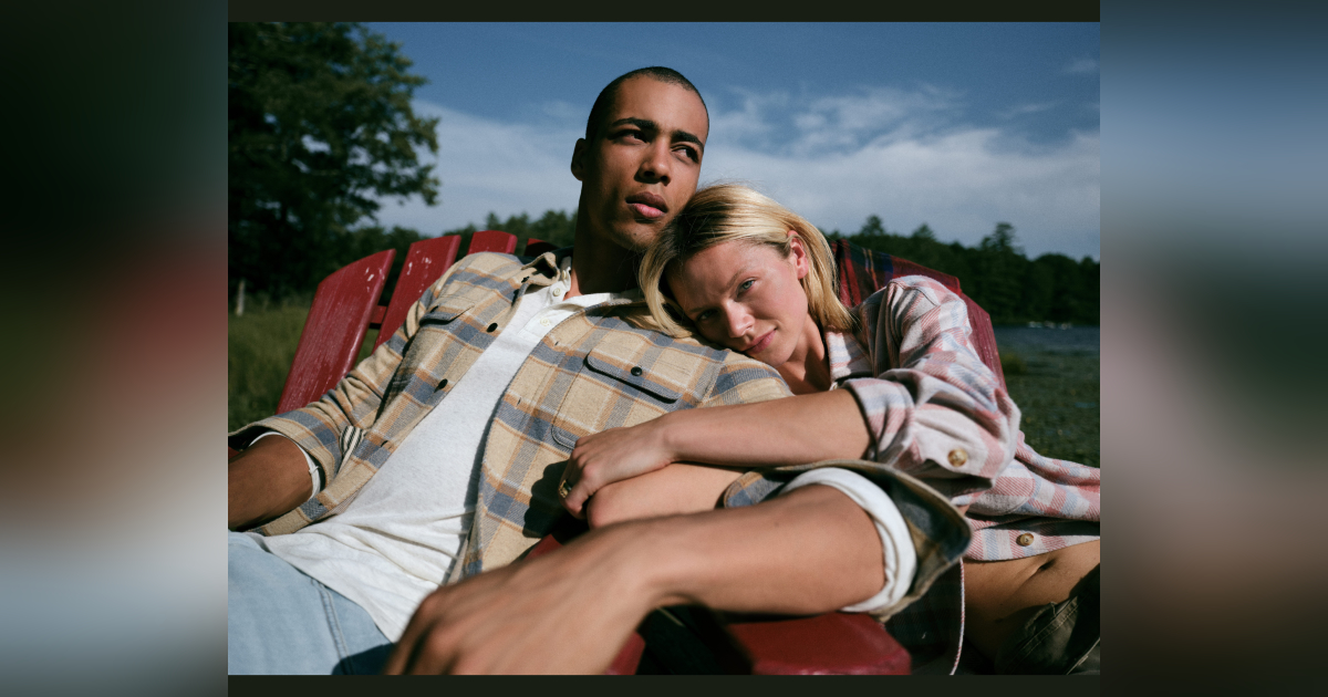 A couple lounging in fall clothes