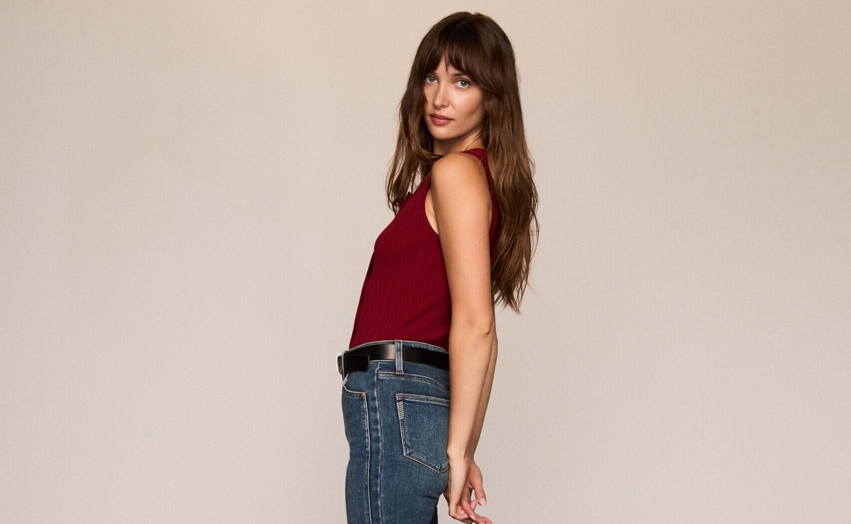 A woman in a casual outfit leaning backwards
