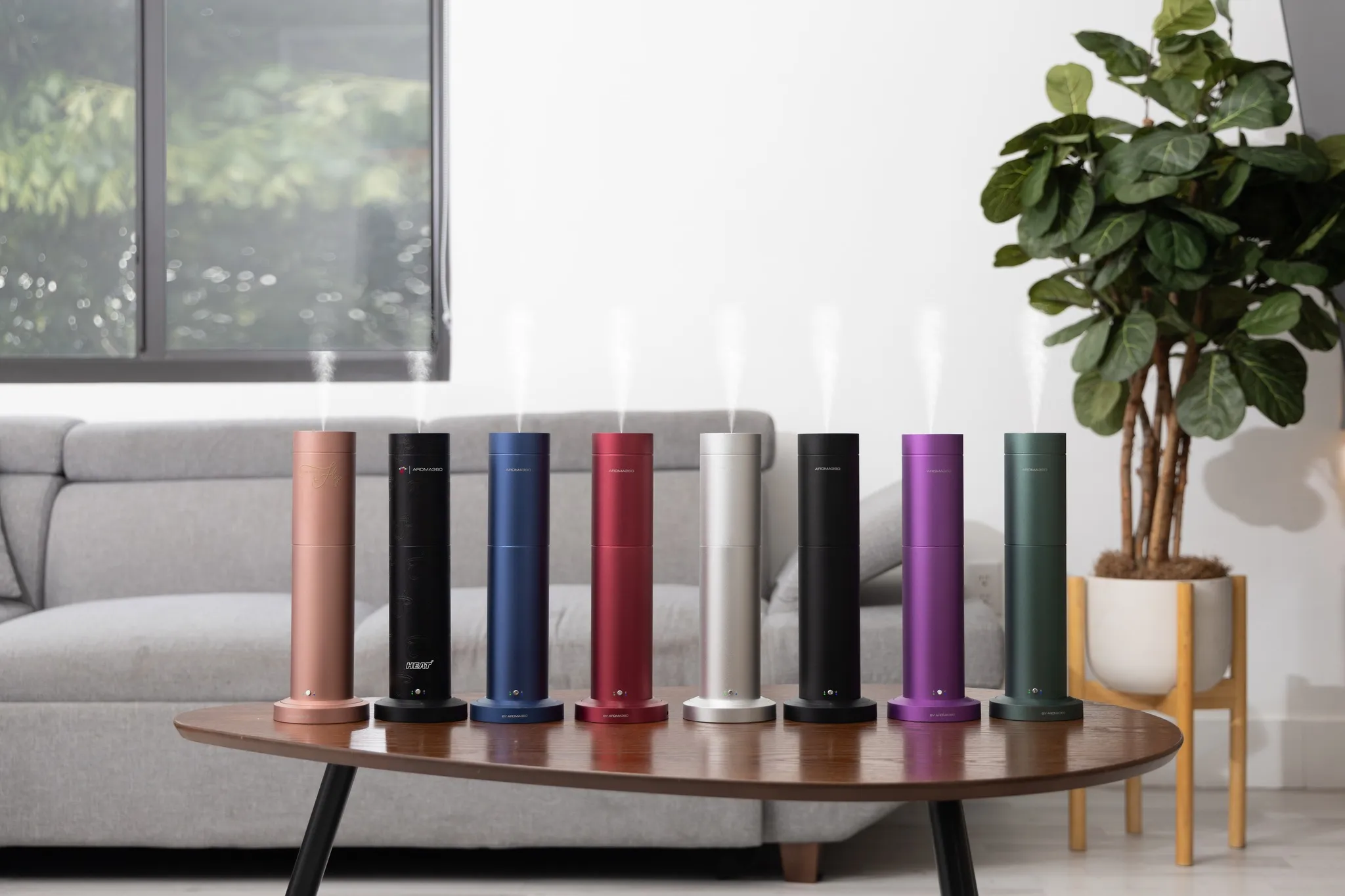 Aroma360 diffusers lined up in a living room
