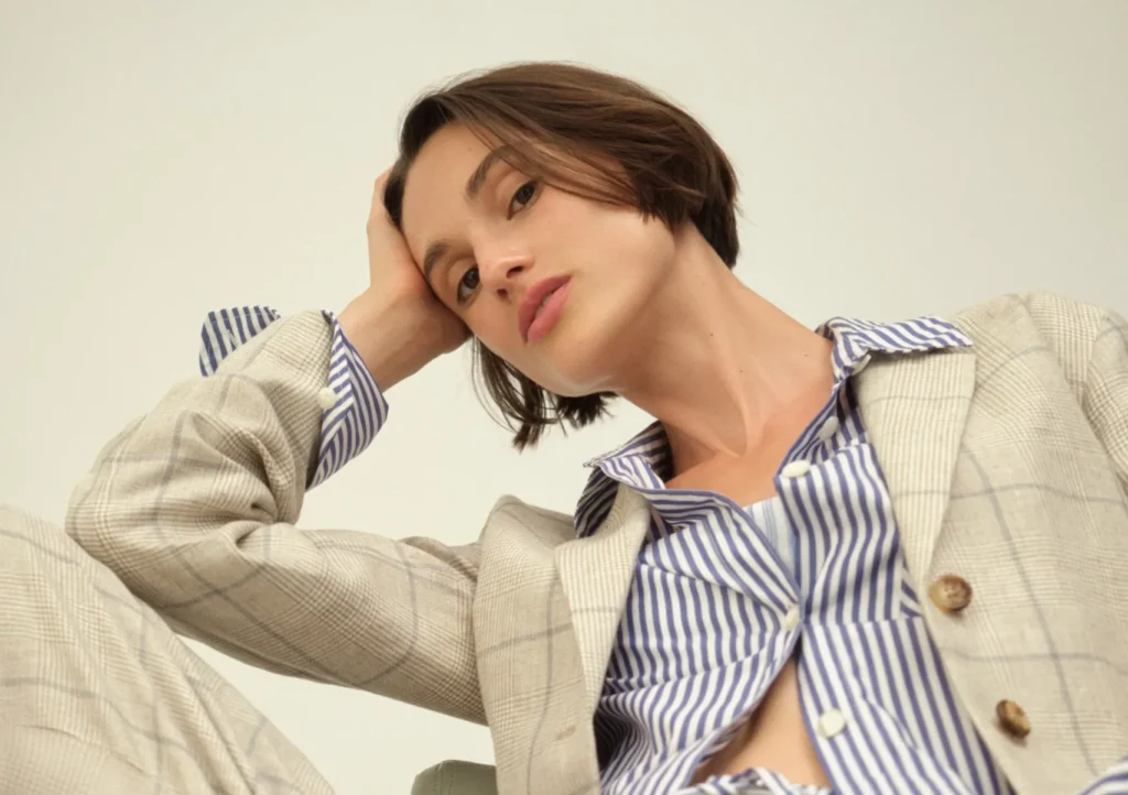 a woman lounging in a suit