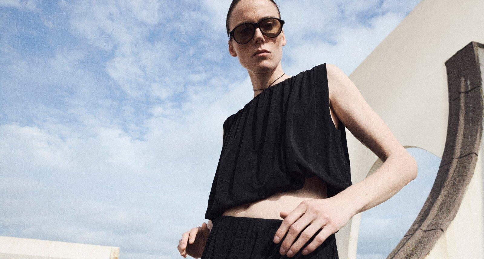 A woman wearing dark clothes and sunglasses from Vince