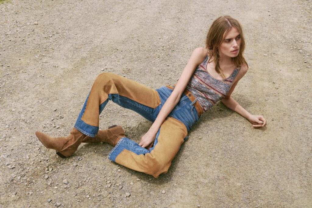 A woman laying on the ground in western attire from Veronica Beard